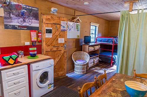 View from the kitchen area to the bunk beds in the Settlers Hut